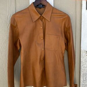 Men’s 100% leather sport jacket.  Camel color leather w/snaps. Super nice!
